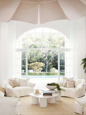 High key living room with an arched window.