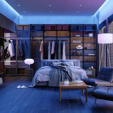 A blue bedroom with mood lighting.